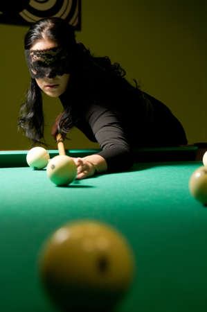 woman in black veil plays billiards