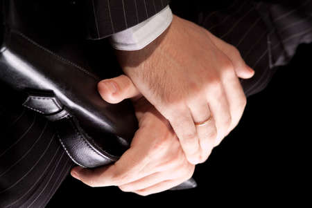 the hands of a businessman carrying a briefcaseの写真素材