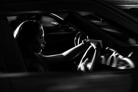 beautiful girl near a black carの写真素材