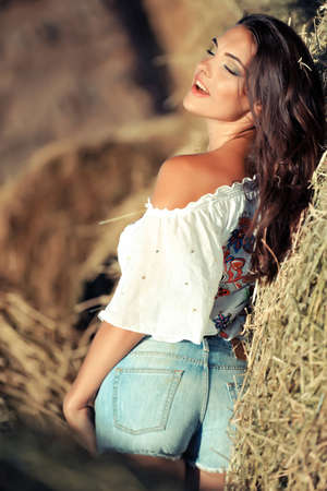 girl in a shirt in the street in the hay