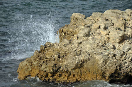 water beating on the stone in the foaming waves sea