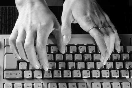Women's gentle hands typing on a keyboardの写真素材