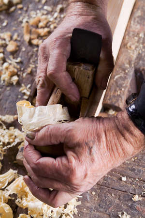 Photo of male hands are made of wood planer