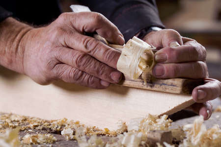 Photo of male hands are made of wood planer