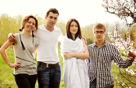 Photo of four friends on nature of the rest of the cityの写真素材