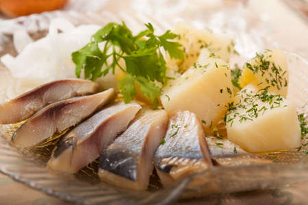 Photo salted herring neatly sliced and laid out on a plateの写真素材