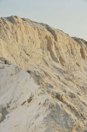 Photo white quarry sand on a background of sky and cloudsの写真素材
