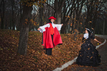 Photo of man and woman in a beautiful theater costumes, in the woodsの写真素材