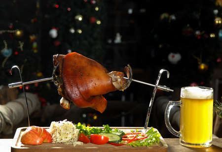 roast leg of a pig with beer on a trayの写真素材