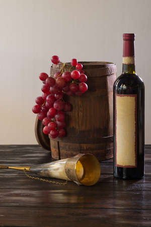 red wine and grapes on a dark backgroundの写真素材