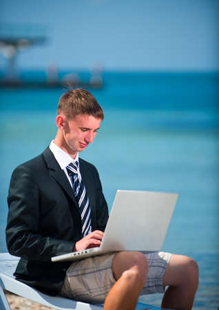 Businessman at the beach with noutbukom.Sevastopo,l Crimeaの写真素材