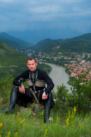 Man in Georgian national dress on a background of mountains