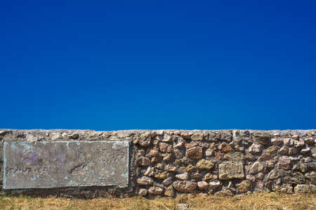 Stone wall against the blue sky