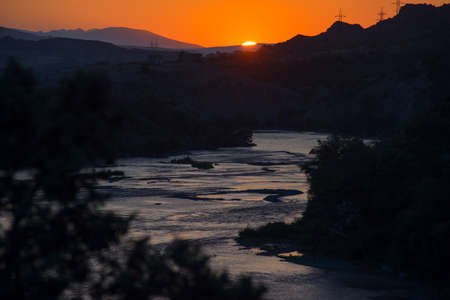 Landscape of the river at sunset. In the background, electric poles. Georgiaの写真素材
