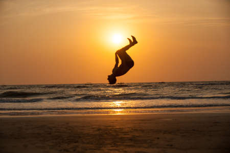 Acrobat man on the beach