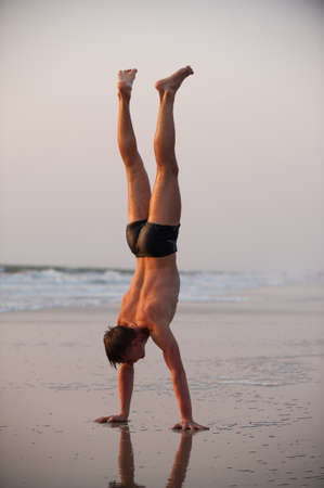 Acrobat man on the beachの写真素材