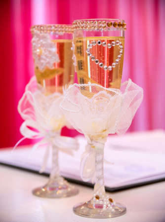 Beautifully decorated wedding glasses on the table.の写真素材