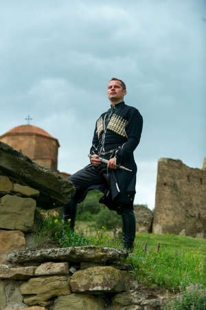 Man in Georgian national dress on a background of mountainsの写真素材