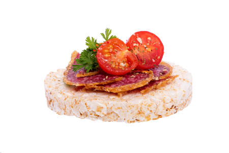 A sandwich with bread, sausage and a tomato.の写真素材