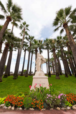 Monument to Jeanne D'Arc in Cannes against the backdrop of palm trees.の写真素材