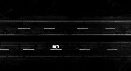 Black and white photo of a car from a bird's eye view.