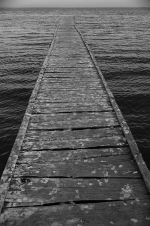 Wooden bridge stretching to the sea.の写真素材