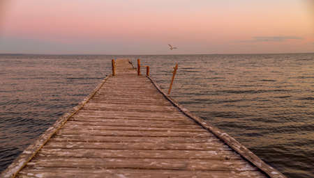 Wooden bridge stretching to the sea.