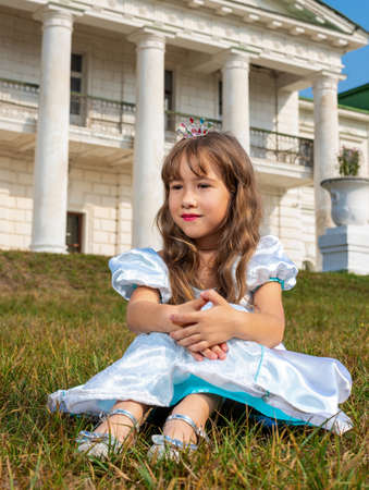 Girl in a princess dress on a background of an old building.の写真素材