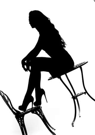 Silhouette of a girl with a beautiful figure on a white background.の写真素材