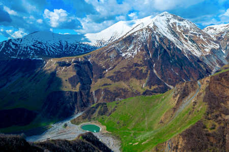 Lake in the mountains of the Caucasus against the background of sky and clouds. Georgia