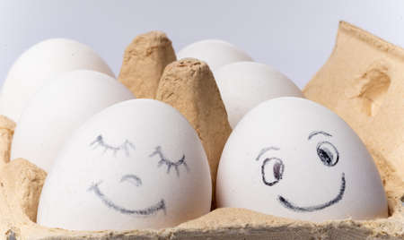 Chicken eggs and emoticons painted on them.の写真素材