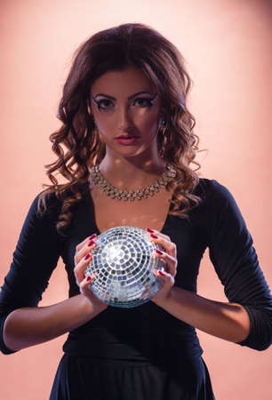 Young woman in a dress with a glowing ball.