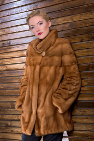 Young woman in a fur coat made of natural fur in the interior.の写真素材