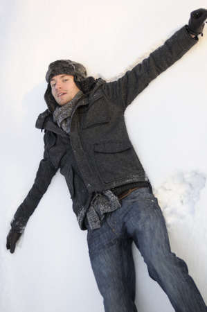 man creating snow angels