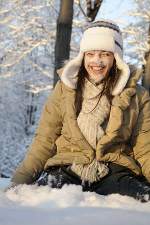 joyful girl laughing with flakes on faceの写真素材