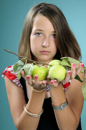 girl showing green applesの写真素材