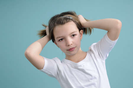 white schoolgirl arranging hairの写真素材