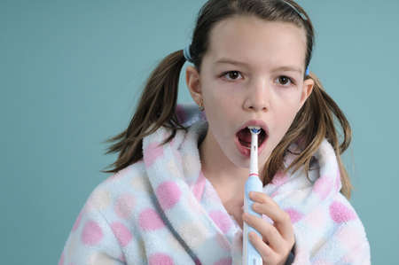 girl washing teeth in bathrobeの写真素材