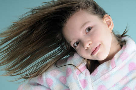 funny girl playing with hair wavingの写真素材