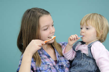 kids cleaning teeth with toothbrushの写真素材