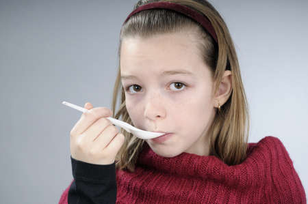 sick girl drinking syrupの写真素材