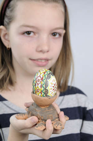girl showing traditional easter egg