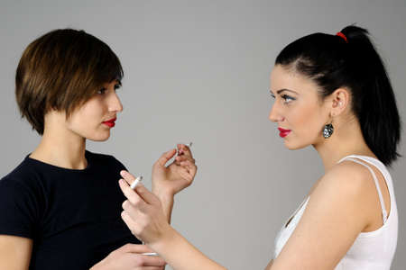 girls smoking togetherの写真素材