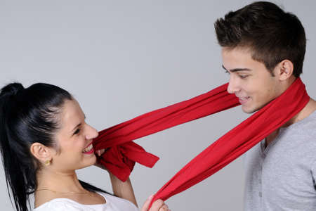 girl playing with red scarf and her partnerの写真素材