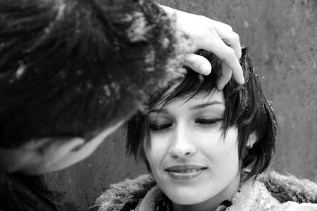 boy arranging hair of young modelの写真素材