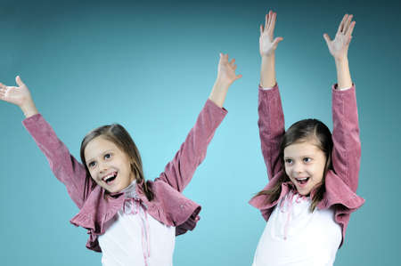 twin girls dancing togetherの写真素材