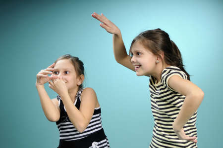 funny twin children having fun at partyの写真素材