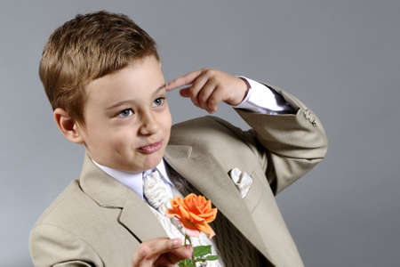 cute little boy offering flowerの写真素材