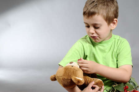 child playing with teddy bearの写真素材