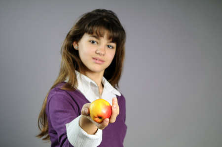 adolescent offering fruitの写真素材